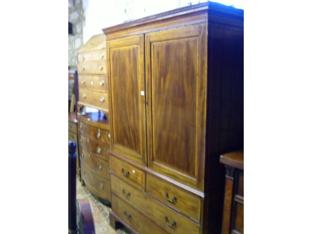 Appraisal: A Georgian mahogany linen press fitted with long and short