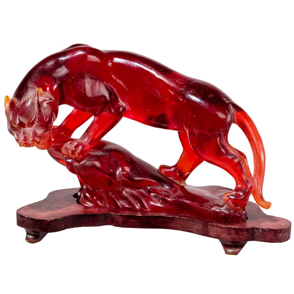 Appraisal: CHINESE CHERRY AMBER STYLE RESIN PANTHERShown perched upon a ledge