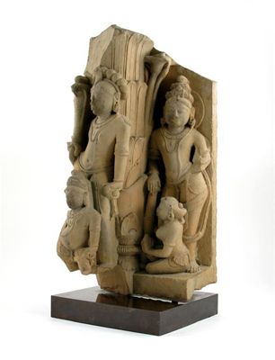 Appraisal: A massive Indian buff coloured sandstone carving possibly depicting Shiva