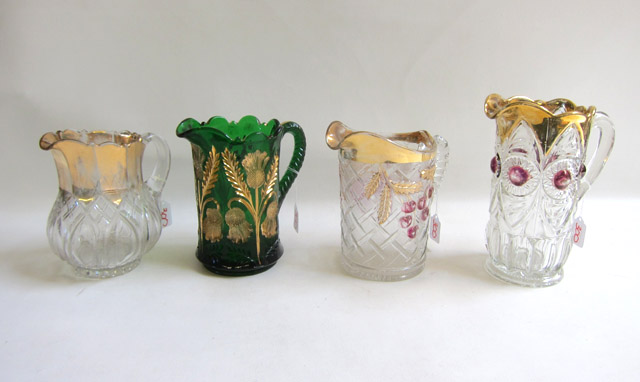 Appraisal: FOUR VICTORIAN PATTERN GLASS PITCHERS by Northwood Moser and others