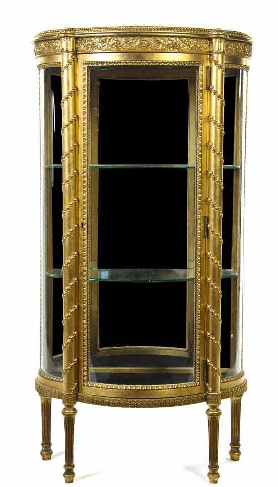 Appraisal: A Louis XVI Style Giltwood Vitrine having a shaped demilune