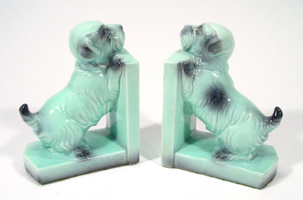 Appraisal: Pair s turquoise glazed pottery dog bookends cm high