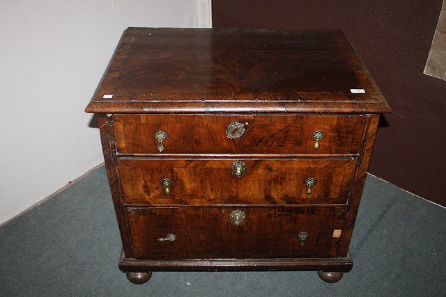 Appraisal: A WILLIAM AND MARY WALNUT CHEST of three graduated drawers