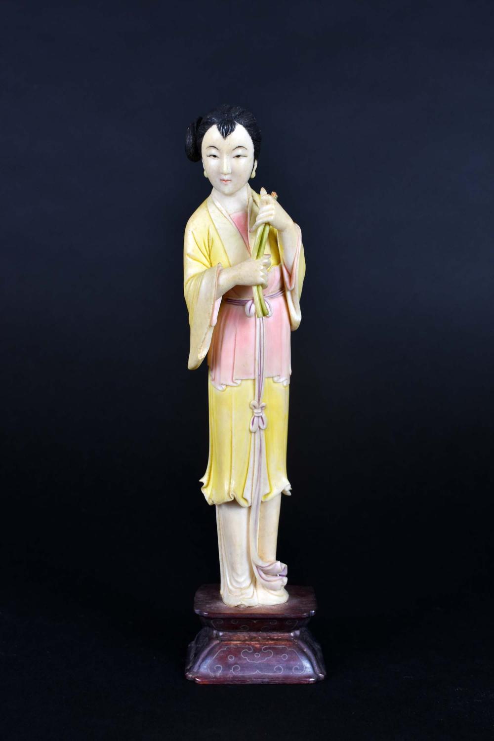 Appraisal: CHINESE CARVED POLYCHROME DECORATED MAIDENThe elegant maiden holds a floral