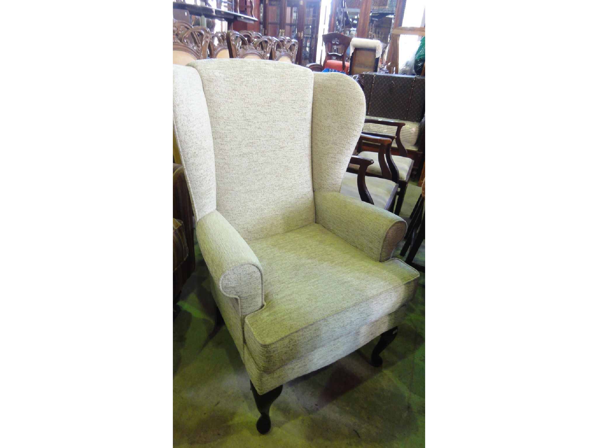 Appraisal: An almost new wing armchair with shaped outline oatmeal ground