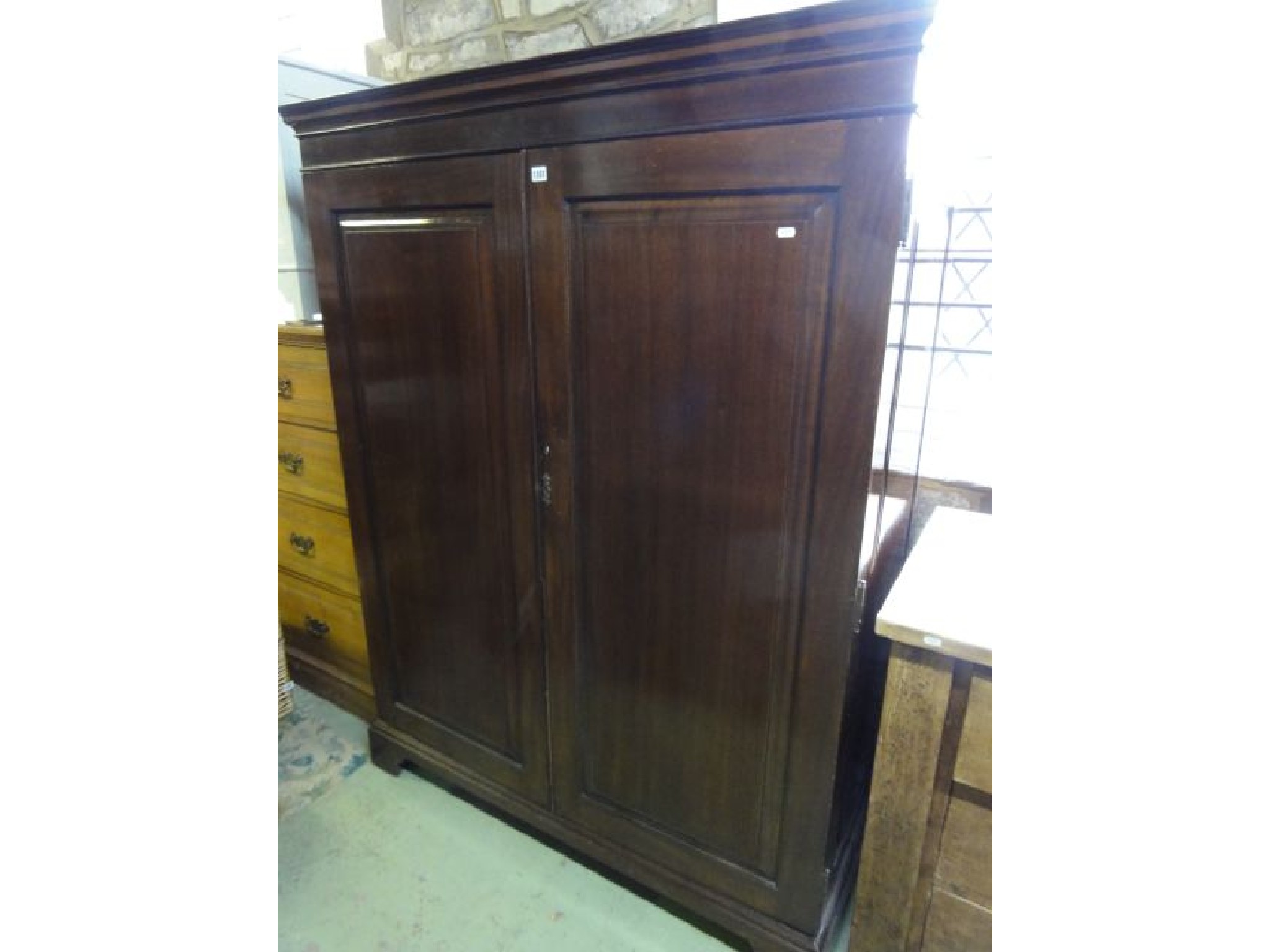 Appraisal: A good quality Edwardian gentlemans mahogany wardrobe enclosed by a