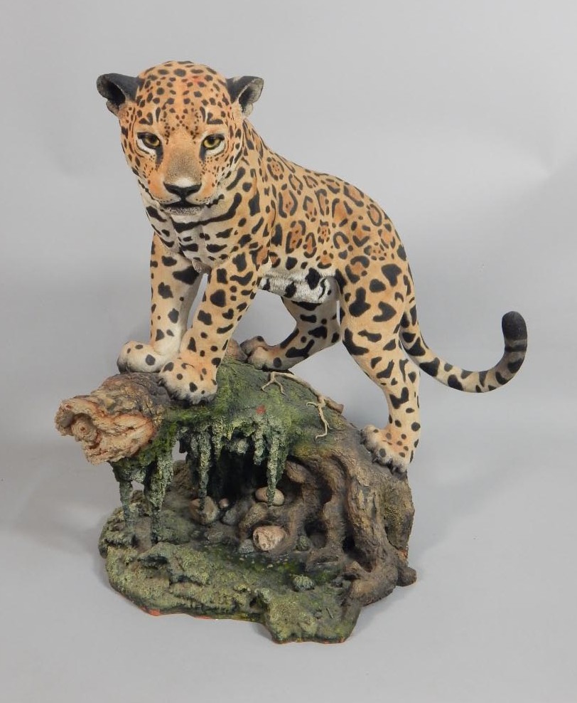 Appraisal: A handpainted composition or resin figure of a leopard on