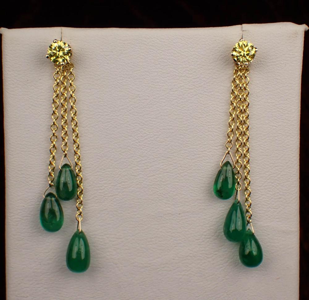 Appraisal: YELLOW DIAMOND EAR STUDS WITH EMERALD EARRING ENHANCERS The k