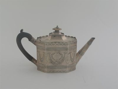 Appraisal: A George III panelled teapot with bright-cut decoration and an