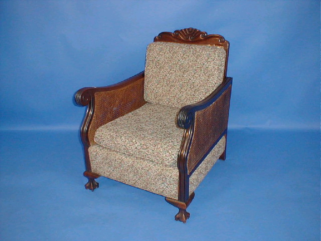 Appraisal: An early thC walnut Bergere armchair with double caned sides