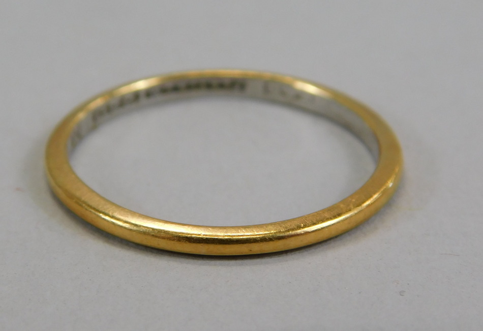 Appraisal: A wedding band with yellow metal exterior and white metal