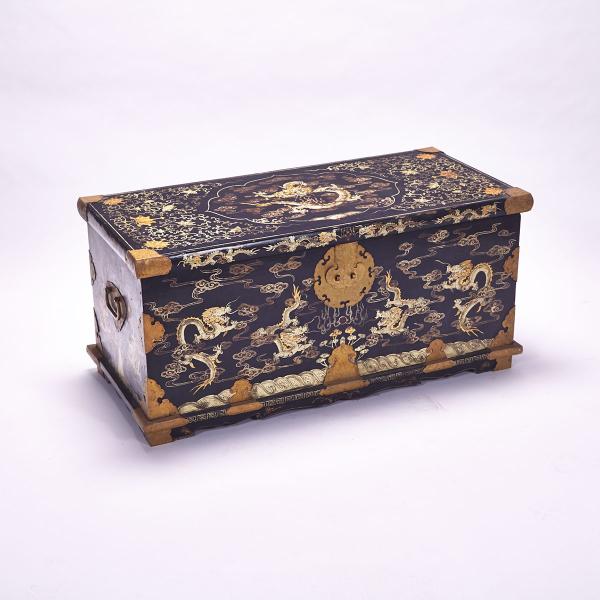 Appraisal: Black Lacquer Dragon Chest Each side depicting dragons and cloud