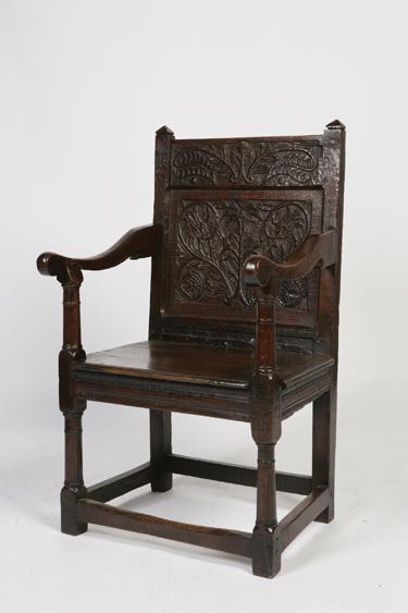 Appraisal: A CHARLES II OAK WAINSCOT ARMCHAIR with a scrolling top