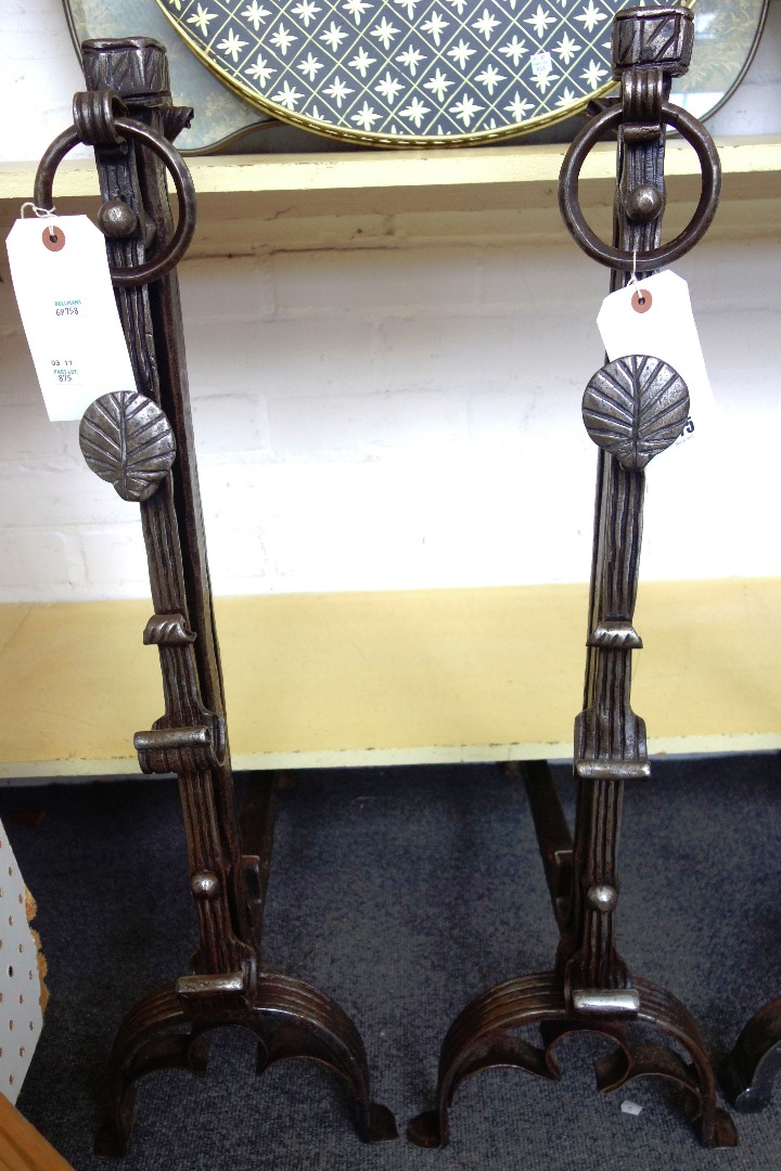 Appraisal: A pair of heavy steel fire dogs with ring finial