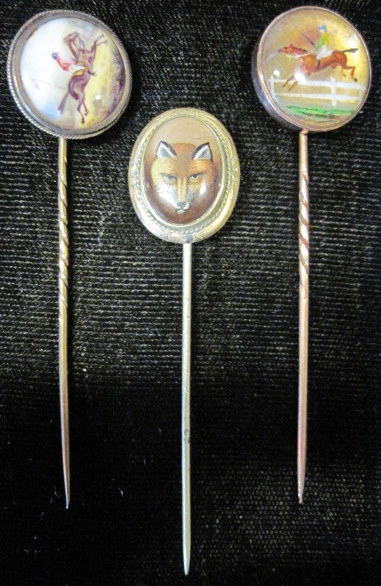 Appraisal: Group of three yellow gold reverse painted stick pinsIncluding two