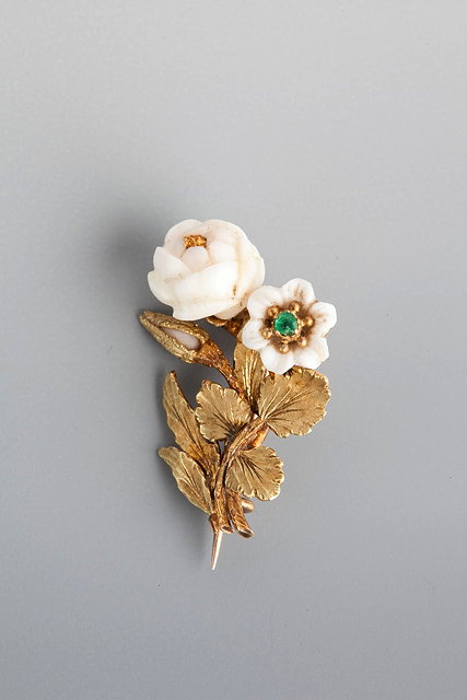 Appraisal: AN EMERALD AND CORAL BROOCH in the form of flowers