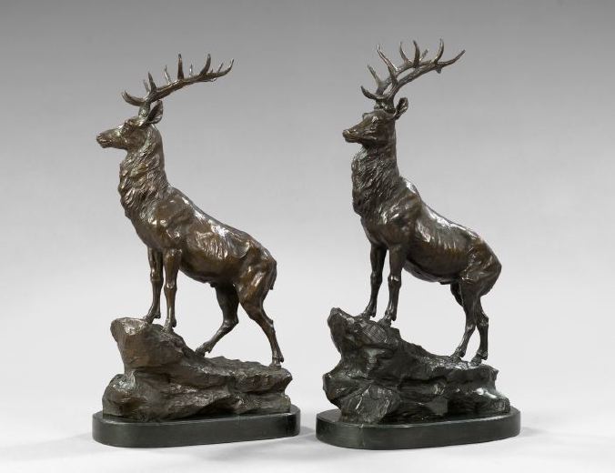 Appraisal: Large Pair of Patinated Bronze Alert Stags Standing on Rocky