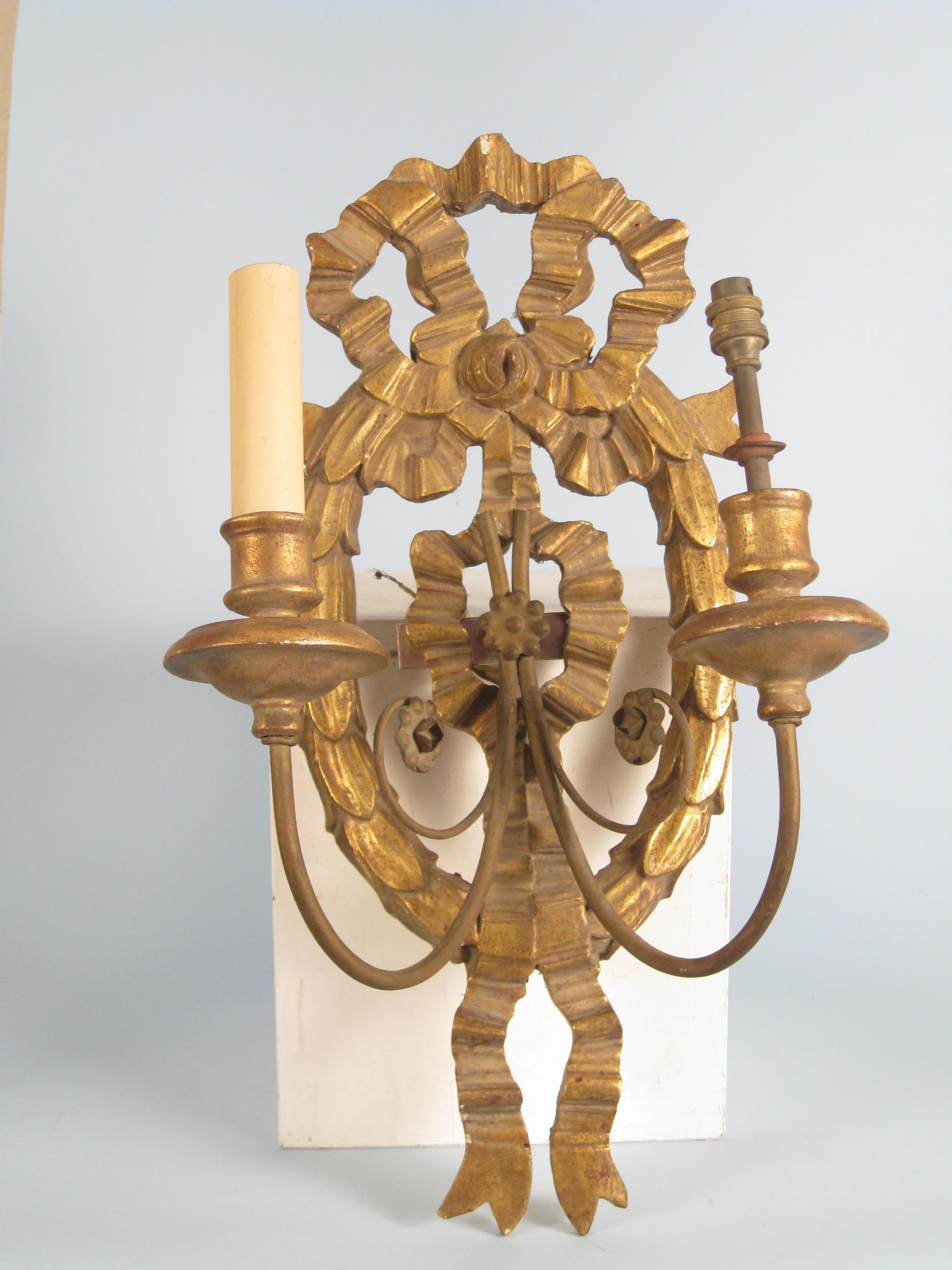 Appraisal: A carved giltwood Wall Sconce with ribbon surmount fitted two