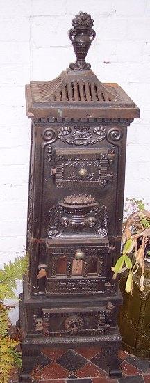 Appraisal: A cast iron stove elaborately decorated with urns etc cm