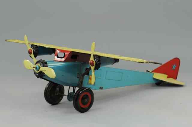 Appraisal: SCHIEBLE TRI-MOTOR TRANSPORT Heavy tinplate blue fuselage with yellow wings