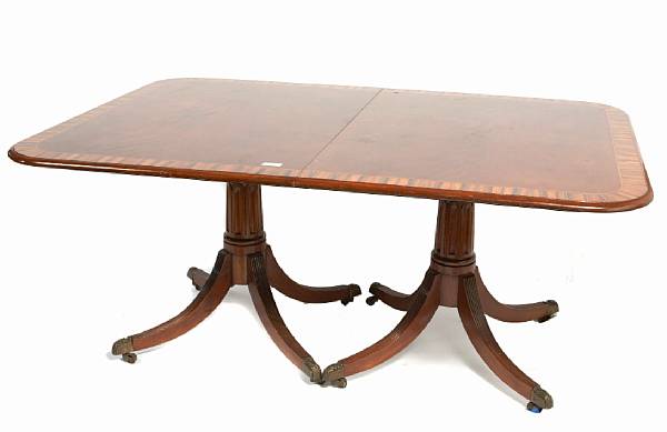 Appraisal: A George III style triple pedestal dining table with rosewood