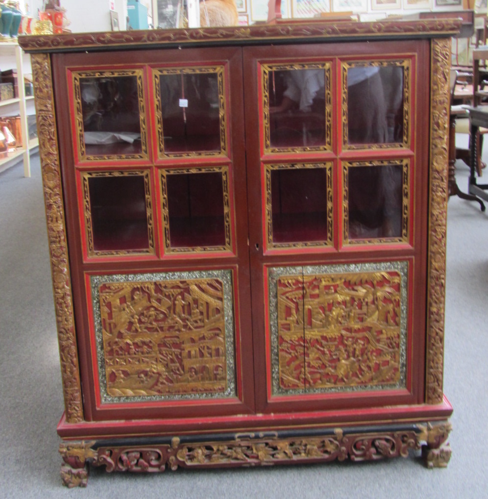 Appraisal: A Chinese red and gilt lacquered two door side cabinet