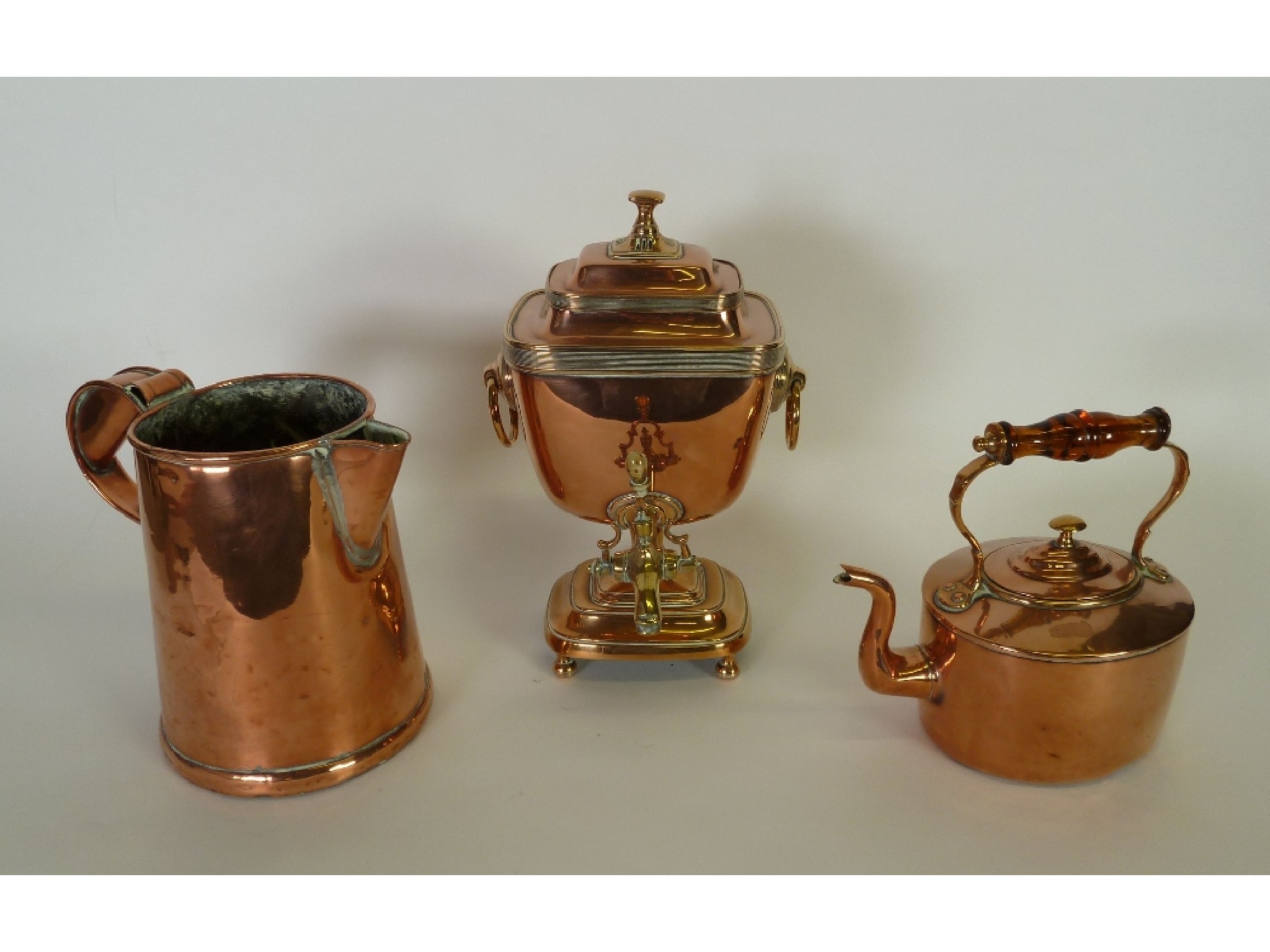 Appraisal: THREE COPPERWARE ITEMS including KETTLE with overhead clear amber coloured