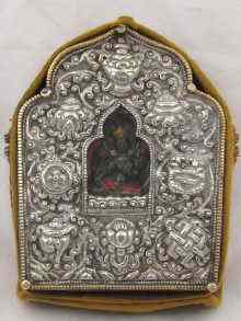 Appraisal: A Tibetan monk's travelling shrine the central deity in embossed