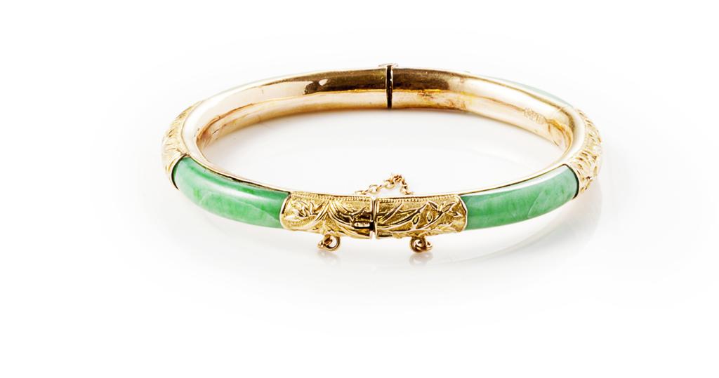 Appraisal: A jade set bangle of hinged design the yellow metal