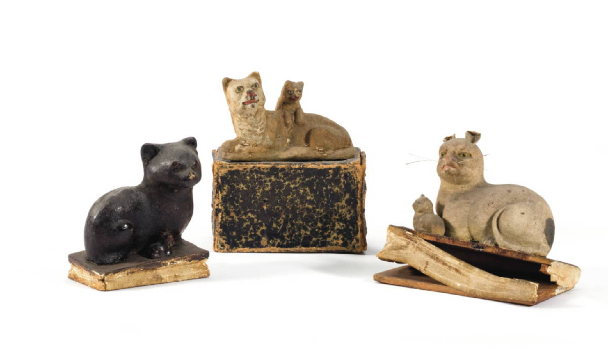 Appraisal: THREE PAINTED OR FELT-COVERED PAPIER MACHE WOOD AND LEATHER FELINE