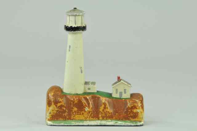 Appraisal: LIGHTHOUSE DOORSTOP Lighthouse keeper's house depicted on rocky shoreline marked