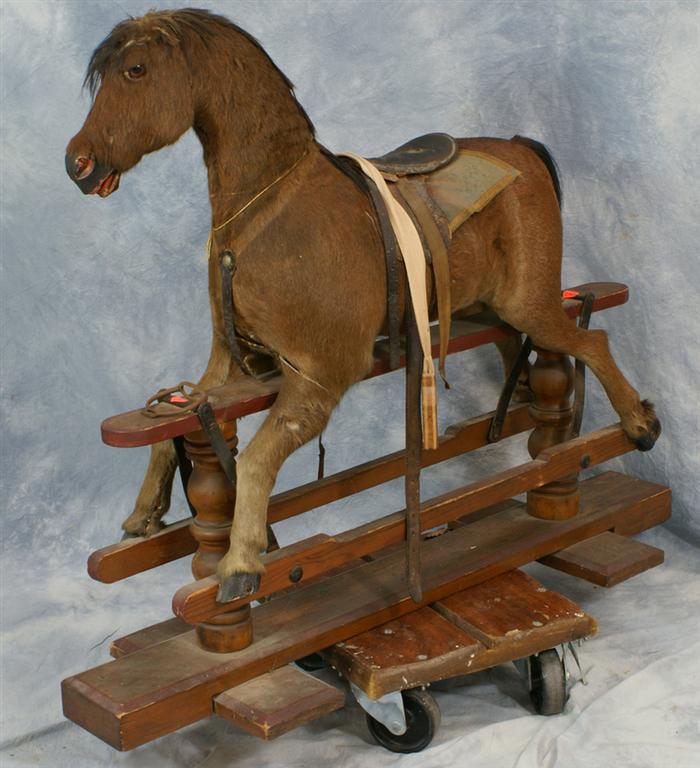 Appraisal: Brown horsehide covered gliding horse English c Estimate -