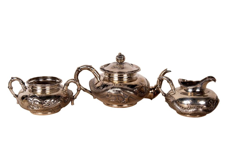 Appraisal: CHINESE SILVER THREE-PIECE TEA SERVICEcomprising a teapot creamer and an