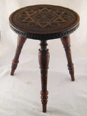 Appraisal: An African hardwood tripod table with carved circular top and