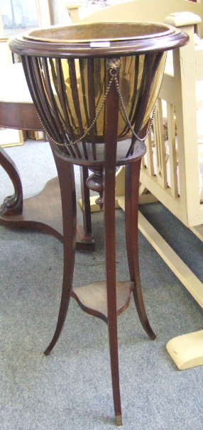 Appraisal: A late th century mahogany jardiniere with brass liner and