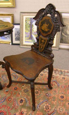 Appraisal: Pair of black forest style side chairs with ornate floral