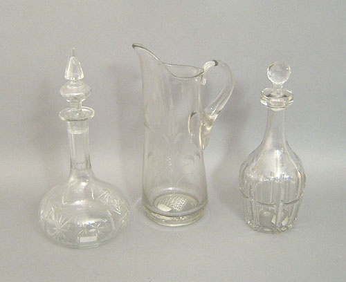 Appraisal: Two clear glass decanters h h together with a pitcher