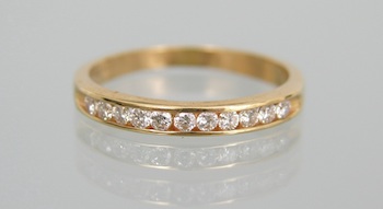 Appraisal: An k Gold and Diamond Band k yellow gold band