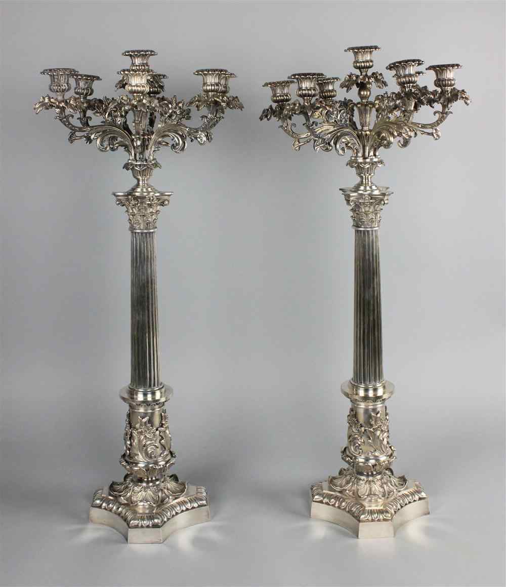 Appraisal: PAIR OF GRAND GEORGIAN SILVERPLATE SEVEN-LIGHT CANDELABRA with scrolling branching