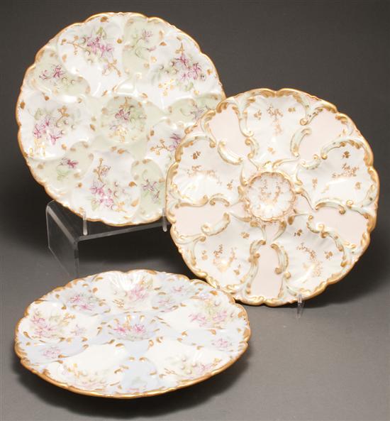 Appraisal: Three Limoges floral painted parcel-gilt porcelain oyster plates late th