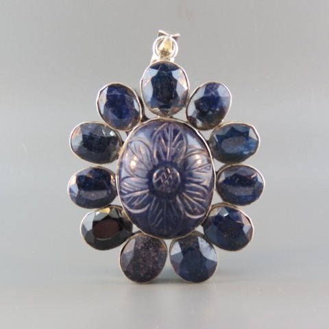 Appraisal: Sapphire Pendant carved African cabachon gem surrounded by oval gems