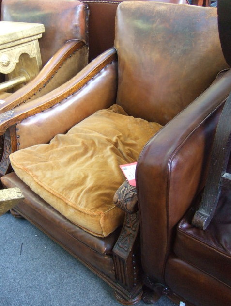 Appraisal: A pair of th century oak and leather upholstered armchairs