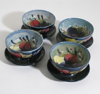 Appraisal: Wisteria' four Moorcroft Pottery bowls designed by Walter Moorcroft painted