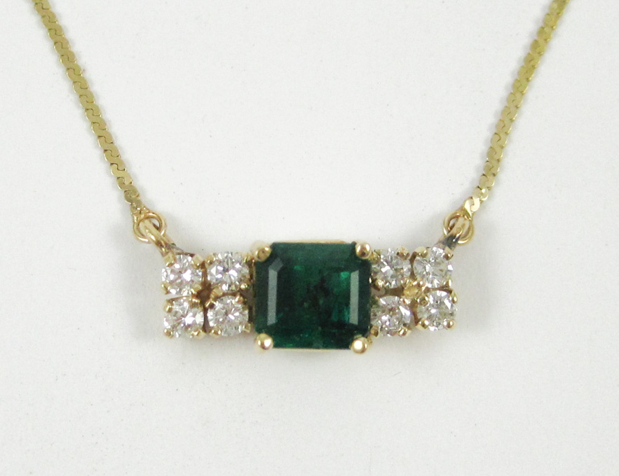 Appraisal: EMERALD AND FOURTEEN KARAT GOLD NECKLACE secured between two lengths