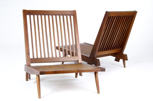 Appraisal: GEORGE NAKASHIMA Pair of walnut slat-back lounge chairs with cushions