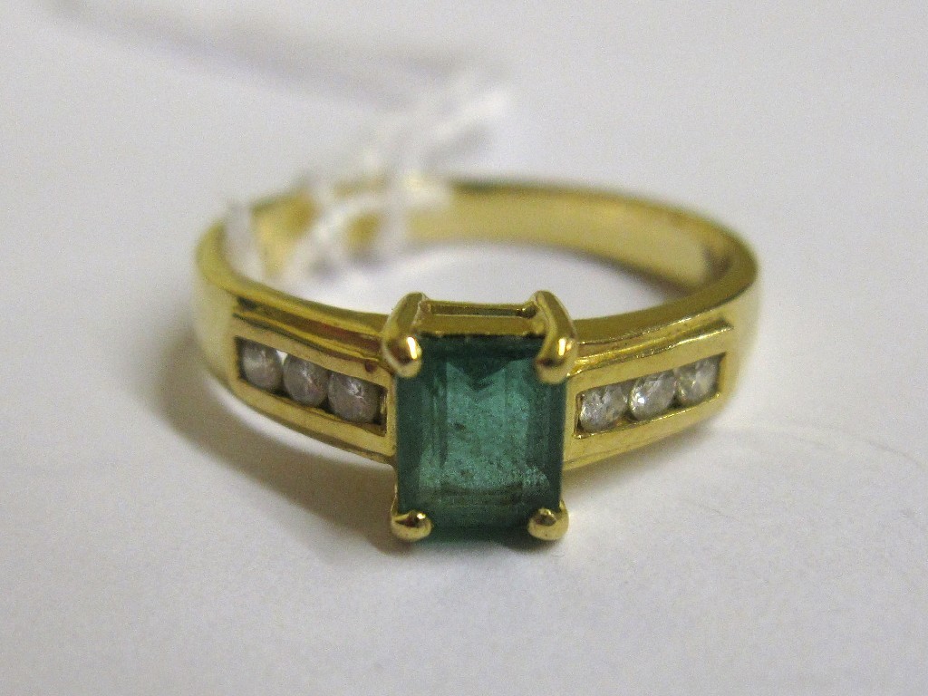 Appraisal: Eighteen carat gold step cut emerald and channel set diamond