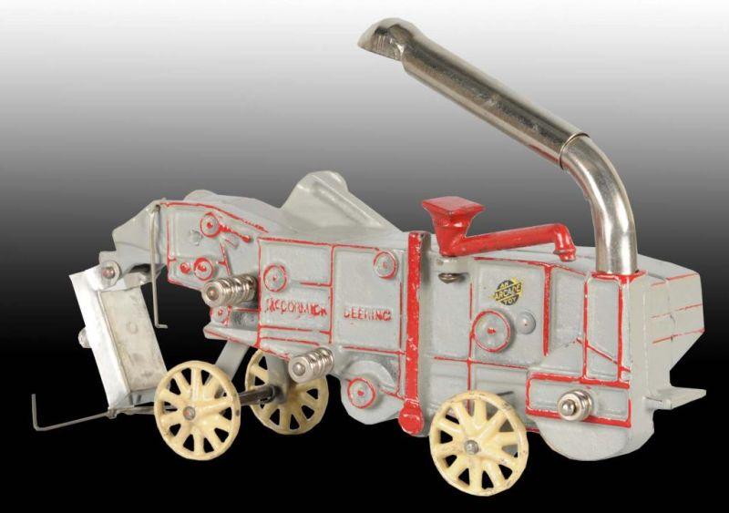 Appraisal: Cast Iron Arcade Thresher Toy in OB Description Includes a