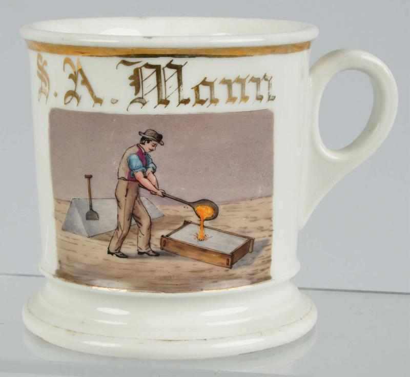 Appraisal: Steel Puddler Shaving Mug Description Nice image of man pouring