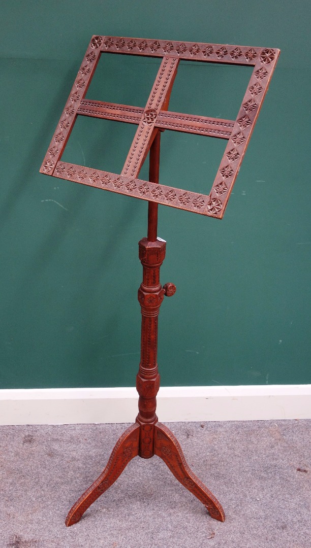 Appraisal: A th century carved sandalwood adjustable music stand on tripod