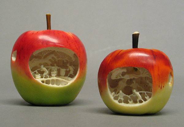 Appraisal: Two polychrome painted ivory apples th Century Of graduated size